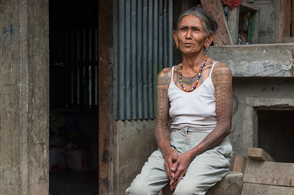 One of the many woman from the hill tribe village that decorate their bodies with tattoos crafted specially by Fang Od