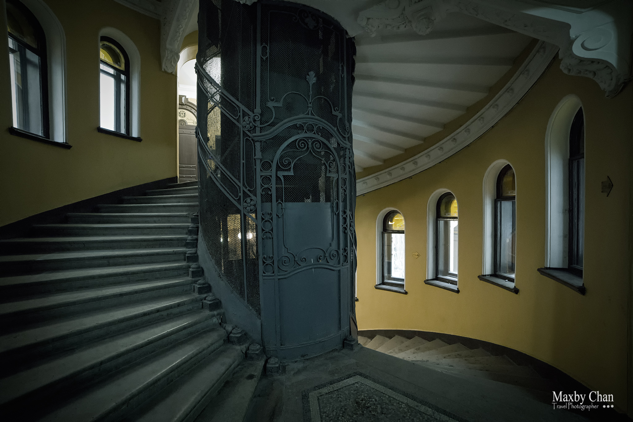 A common spiral staircase with a lift at the central core.
